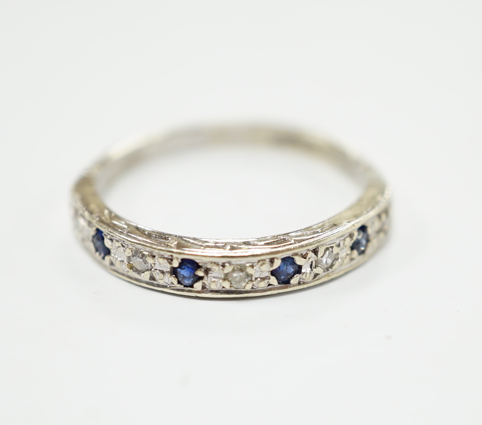 A modern 9ct white hold sapphire and diamond chip set half hoop ring, size N, gross weight 2.1 grams.